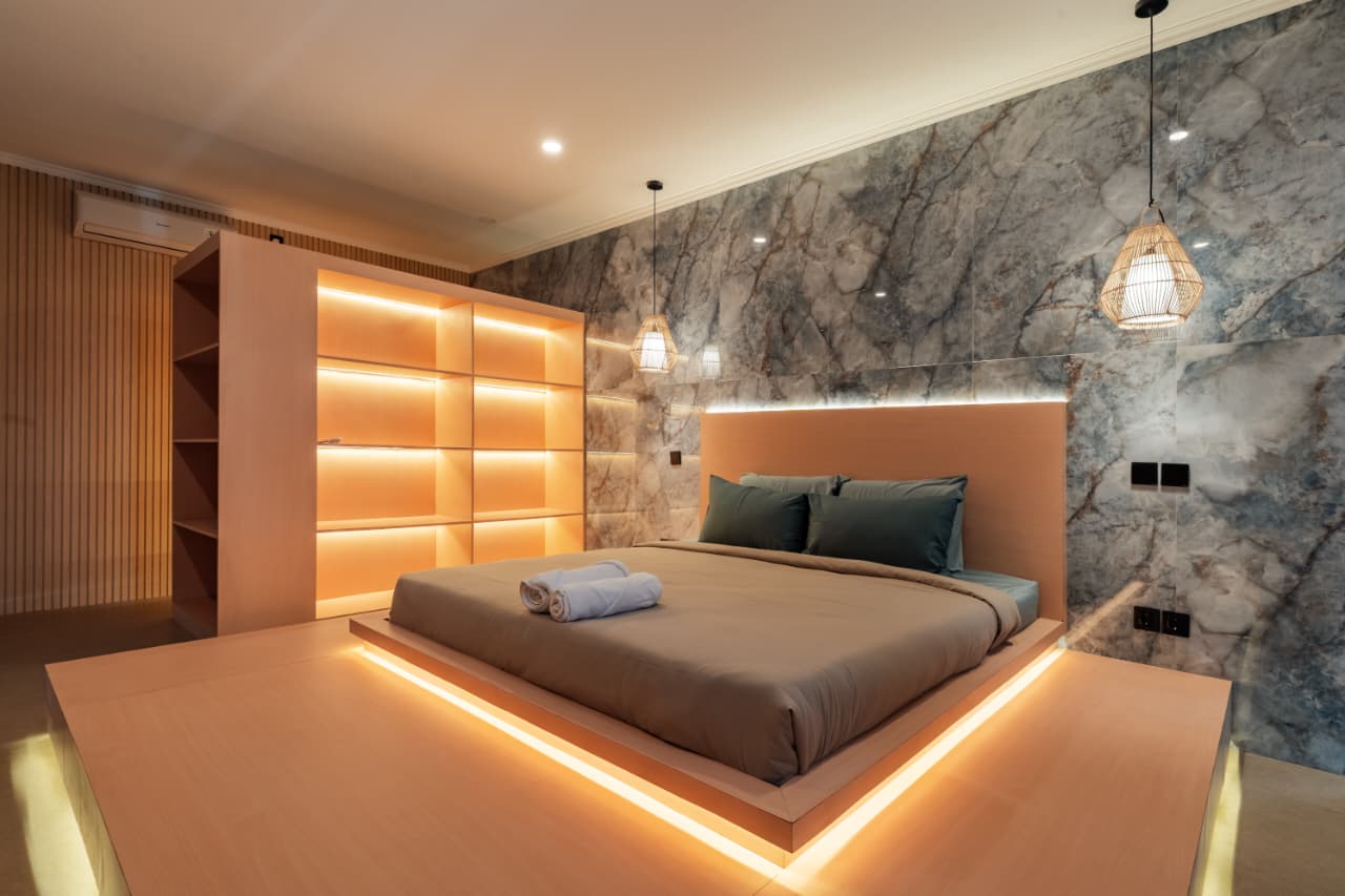 Master bedroom with backlit floating bed at Villa Ikigai